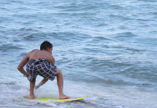 Miami Beach, Florida, USA-August 27,2009:Unidentified Young Man Surfing at Miami Beach in a Hot Summer Day