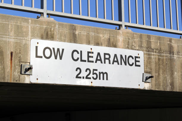 istock Low Clearance height limit sign attached to a concrete underpass 2175828615