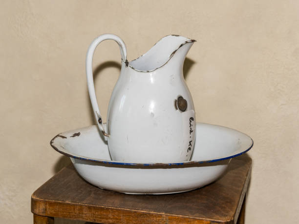 istock An old white metal jug standing on a table 2175829138