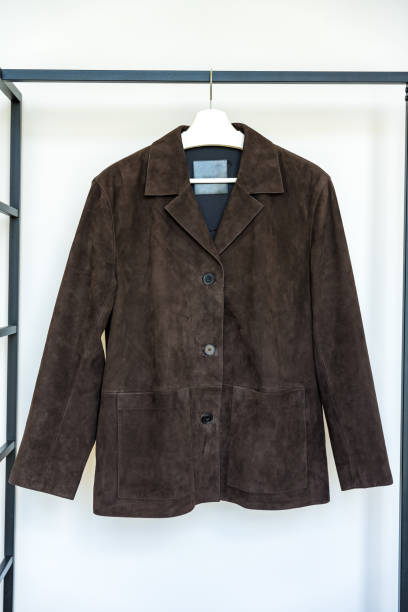 istock Dark brown suede jacket with patch pockets hanging on a hanger. Fast fashion concept 2175832523