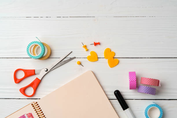 istock Creative workspace with open notebook, stationery, and decorative items on a wooden table 2175832652