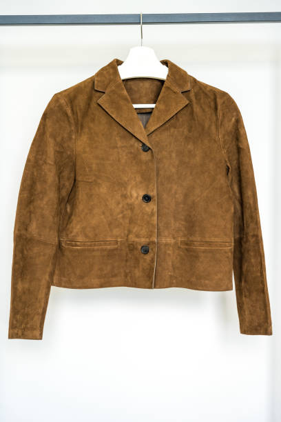 istock Light brown suede jacket with patch pockets hanging on a hanger. Fast fashion concept 2175833360
