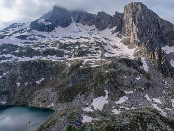 istock Snow-Dusted Mountain Peaks and Alpine Lake 2175835863