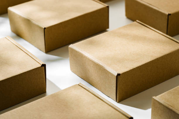 istock Brown cardboard boxes arranged on a light surface for packing goods in a warehouse setting 2175837110
