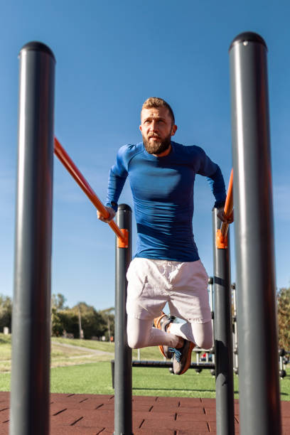 istock Young Man Exercising in Outdoor Gym 2175837476