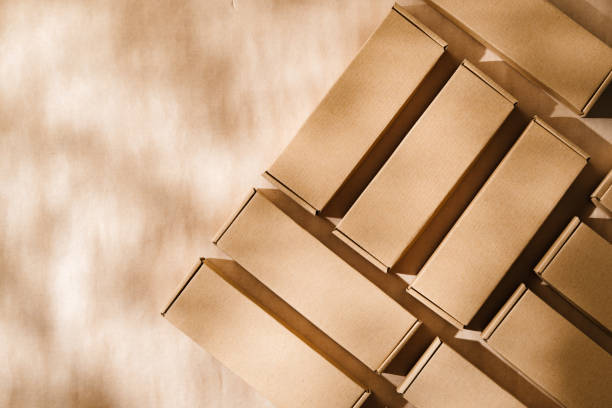 istock Brown cardboard boxes arranged on a neutral background in a warehouse setting during daylight hours 2175838399