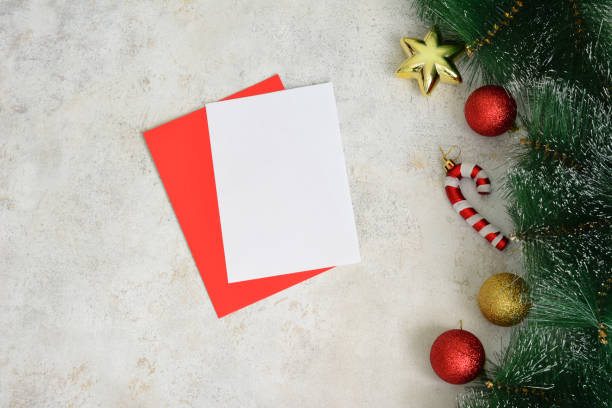 istock a christmas card with a red envelope and spruce branches with christmas ornament 2175843256