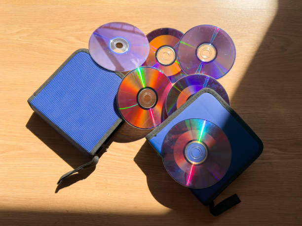 stack of music discs on cd and multimedia dvd collection. blue protective sleeves.