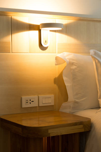 istock Wall lamp providing bedside lighting with a warm glow. 2175844551