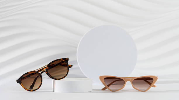 istock Classic tortoiseshell frame and trendy cat eye frame sunglasses on podiums on white background. Minimal still life. Copy space. Optic store discount, sale, promotion. Sunglasses creative concept. 2175844611