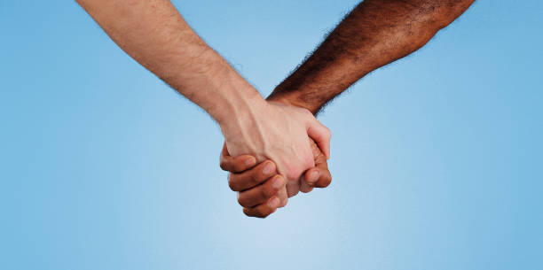 istock Love, unity and people holding hands in studio for change, collaboration and kindness in solidarity. Friends, trust and gesture of support on blue background for human rights, care or racial equality 2175844810
