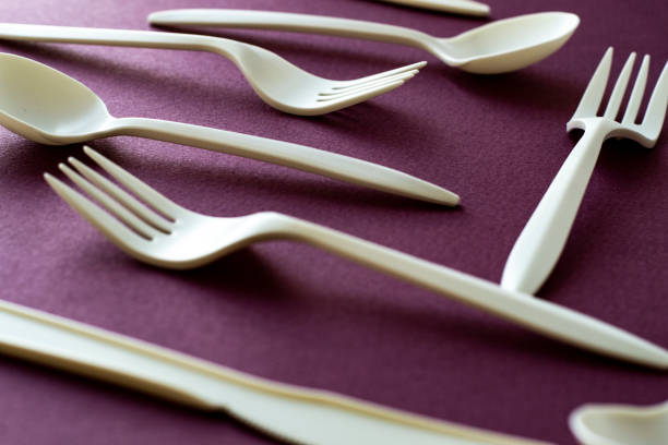 istock forks and spoons on colorful dark violet background 2175846720