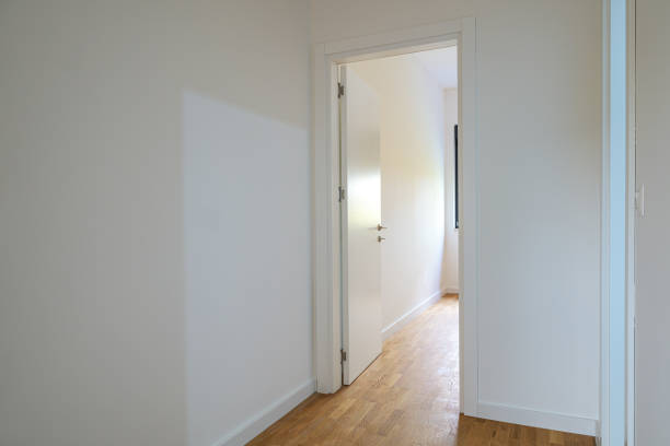 Modern new empty apartment interior with white wooden doors, selective focus