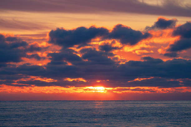 Dramatic cloudscape over the sea horizon sunrise seascape
