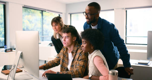 istock Diverse Group of Students Engaged in a STEM Lecture Room, Collaborating and Focusing on a Computer Screen 2175848494