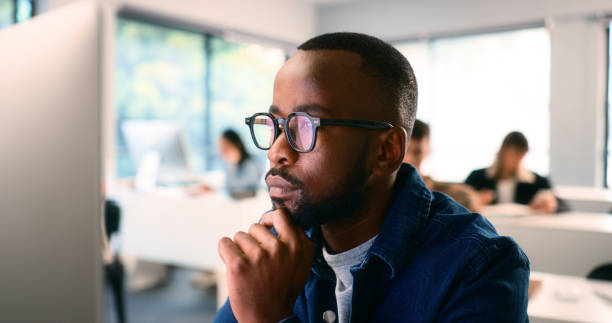 Diverse Group of Students Attending a STEM Lecture in a Modern Classroom Environment stock photo