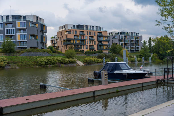 Prague, Czech Republic - September 16, 2024: Luxurious residence of modern architecture DOCK with a marina and yachts next to the Vltava river on a cloudy autumn day.