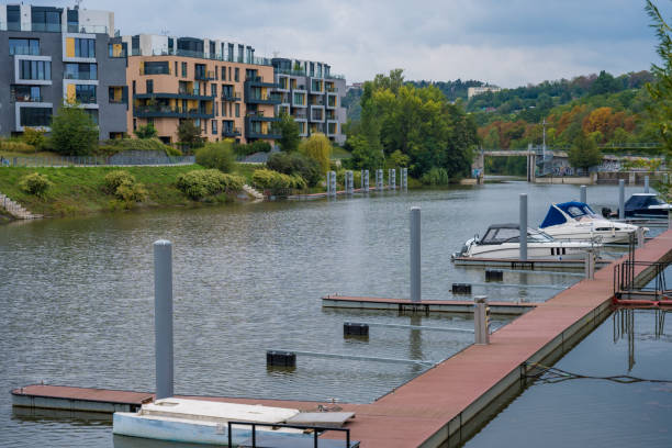 Prague, Czech Republic - September 16, 2024: Luxurious residence of modern architecture DOCK with a marina and yachts next to the Vltava river on a cloudy autumn day.