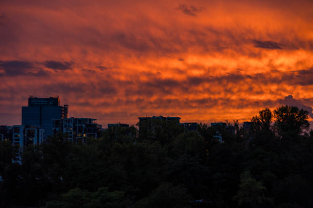 Prague, Czech Republic - September 12, 2024: A dramatic red sunset sets the sky ablaze over the Holesovice district, just before the onset of extreme weather and flooding. The calm before the storm.