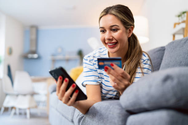 istock While relaxing on sofa, young Caucasian woman typing credit card info, while making online purchases 2175856908