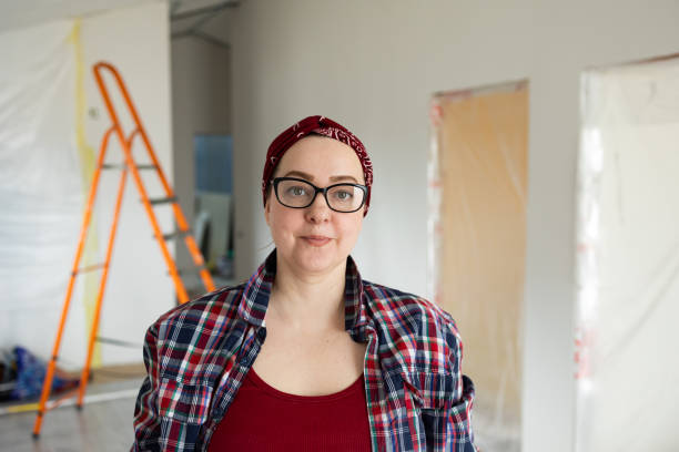 istock A woman actively involved in the construction field, using a ladder while ensuring paint safety 2175859564