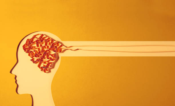 A paper human figure cut out with a paper brain shape