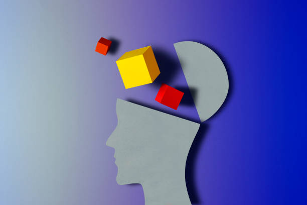 A human paper head with while cubes of different colours shaped as a human brain
