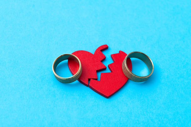 istock Wedding ring with broken heart on blue background 2175870797