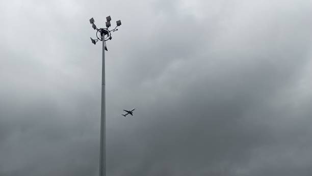 istock dark cloudy sky with planes and lampposts 2175871776
