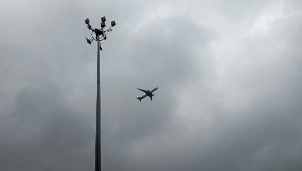 istock dark cloudy sky with planes and lampposts 2175871795