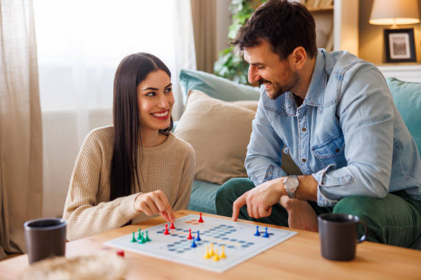 istock Couple in love having fun playing ludo board game 2175873201
