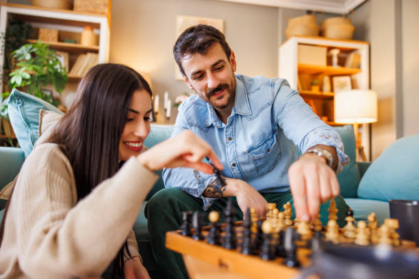 istock Couple enjoying leisure time at home playing chess 2175873635