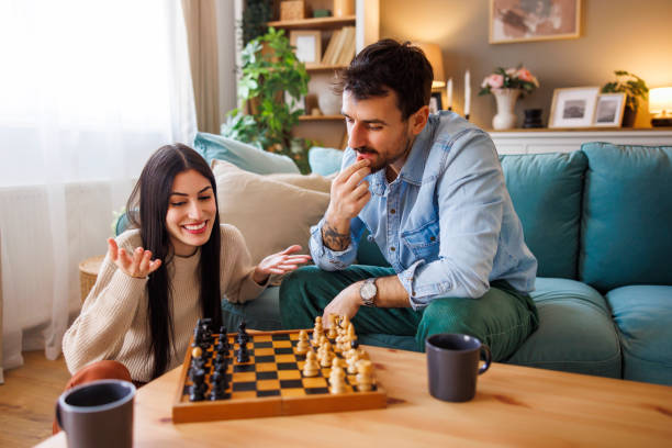 istock Couple in love having fun playing chess at home 2175873914