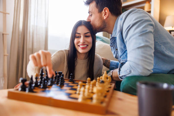 istock Couple relaxing at home playing chess 2175874099