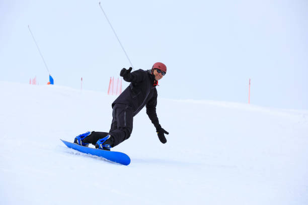 Snowboarding   Man snowboarding  on the mountain ski resort, perfect ski slope.