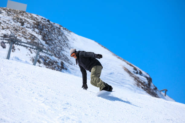 istock Snowboarding   Man  snowboarding  on the mountain ski slope 2175874520