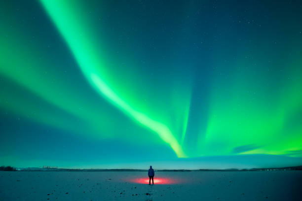 istock Tourist with red flashlight standing on snowy field 2175874846