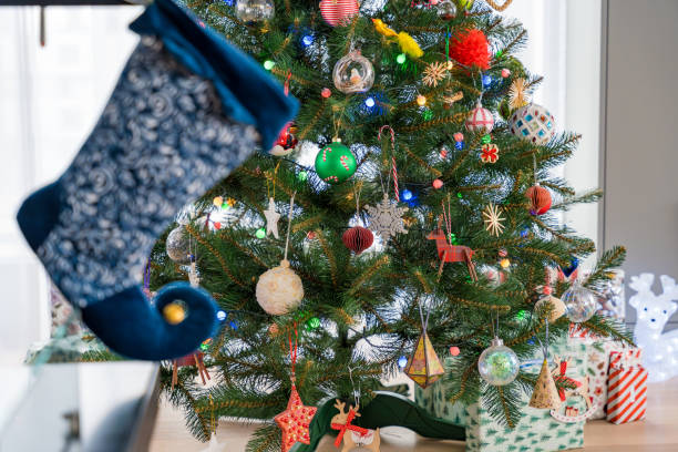 istock Christmas stocking hanging near a beautifully decorated tree 2175877891