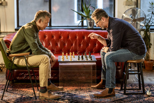 Concentrated Mature Adults Engage in Chess Game