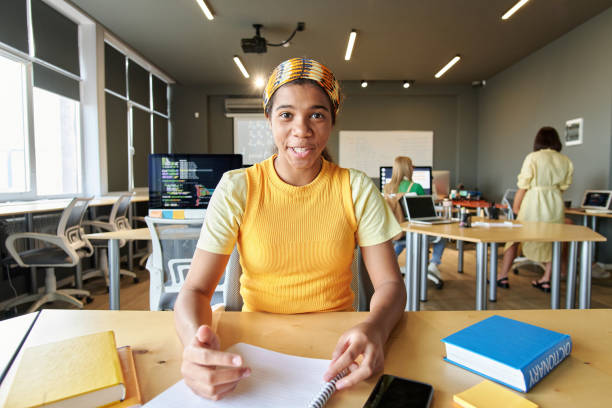 istock Black Girl Smiling Sitting using Video Chat at School 2175880067