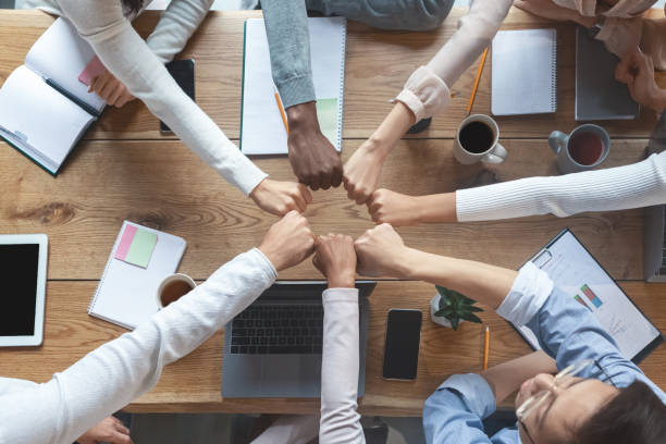 istock People putting fists together for cooperation, cropped 2175880536