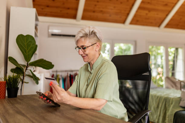istock Woman browsing smartphone at desk in modern office. 2175882802