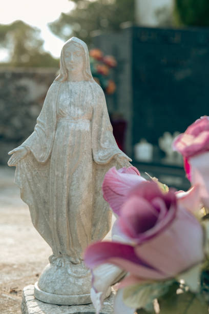 Artificial flowers on a cemetery grave .