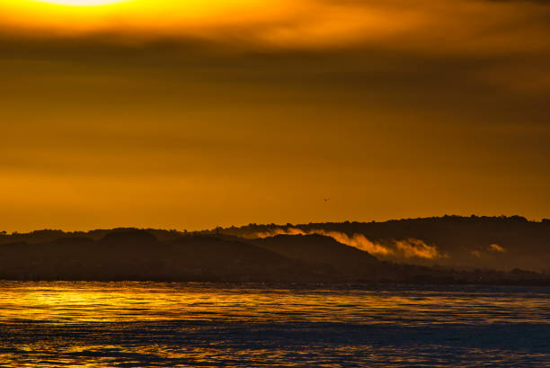 Tranquil scene at dawn with sunlight reflected onto water surface