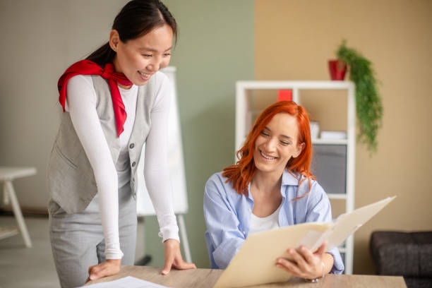 istock Women in engaging workplace meeting with documents 2175891231