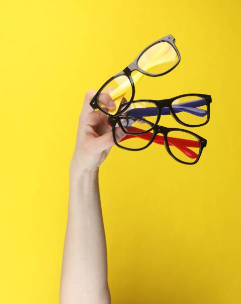 istock Hand holding eyeglasses on yellow background 2175896236