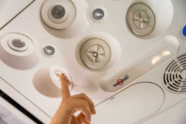 istock Close up of a child adjusting the overhead panel on an airplane 2175897503