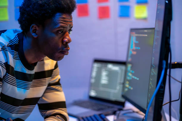istock Empowered specialists, IT professionals, work late in a high-tech research center, focused on developing advanced software, artificial intelligence interfaces, and cloud computing solutions with coding. Seated at desks with laptops and multiple screens. 2175900555