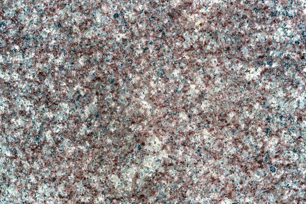 The polished granite surface background features a smooth, reflective finish with natural variations in color and pattern.