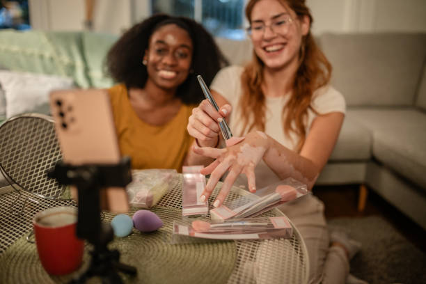 istock Smiling duo demonstrating beauty tools at home. 2175903145